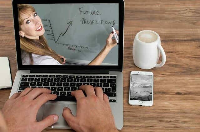 Laptop with a woman presenting marketing strategy on a video