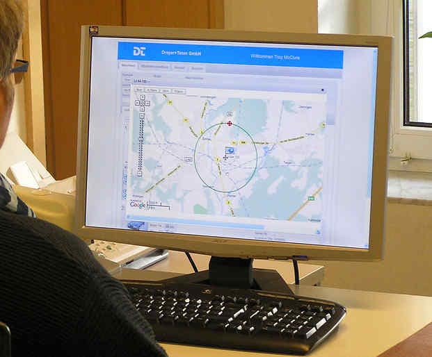 Woman looking at a computer with geofencing displayed on the monitor