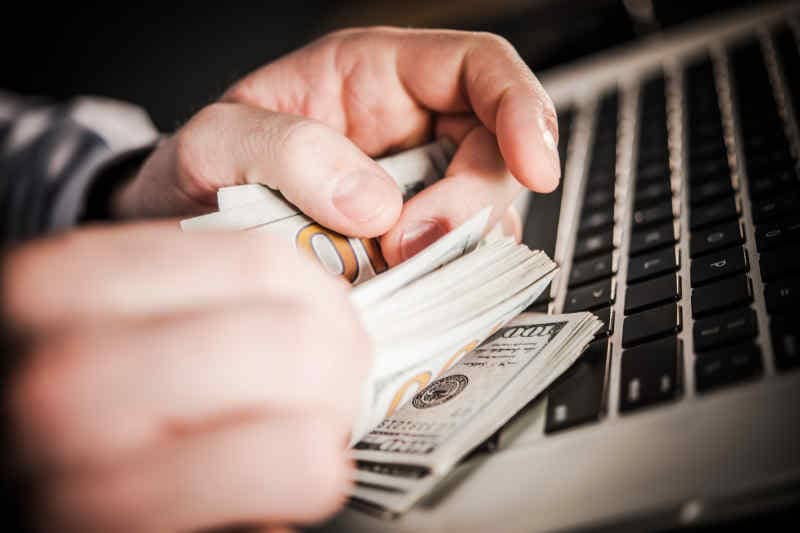 man counting money from website